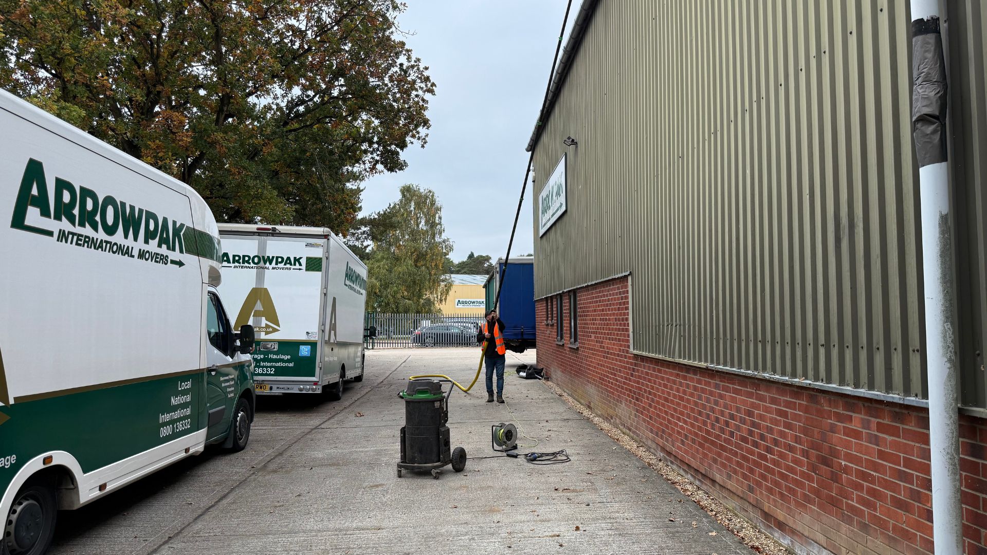 Commercial gutter cleaning with a vacuum system at an industrial unit