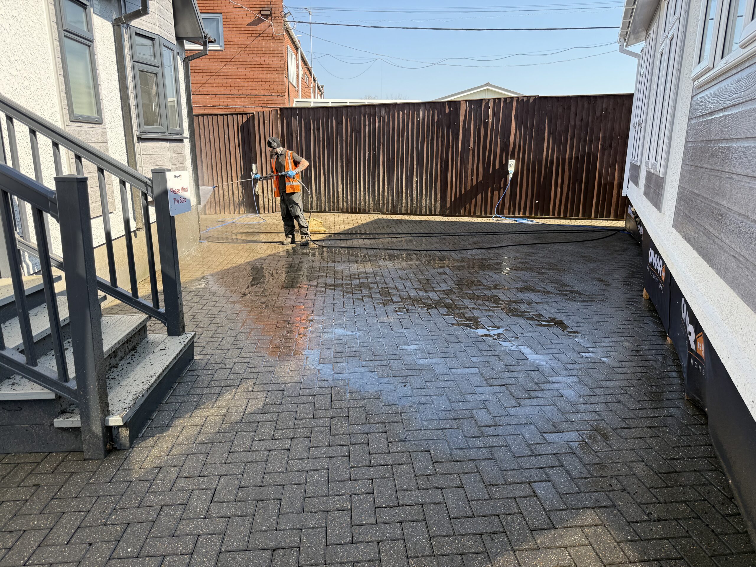 Pressure washing block paving on a park home site