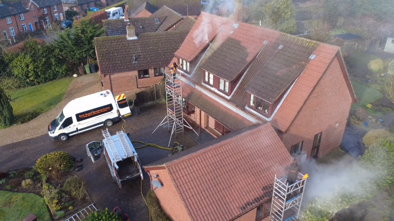 Residential roof being professionally cleaned